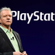 PlayStation president Jim Ryan standing in front of the company's logo.